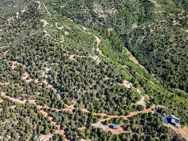 Expansive aerial view of a mountainous landscape with dense tree coverage