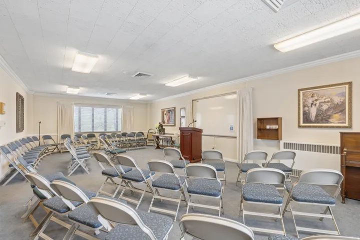 Spacious room featuring neutral-toned walls, recessed lighting, and a drop ceiling