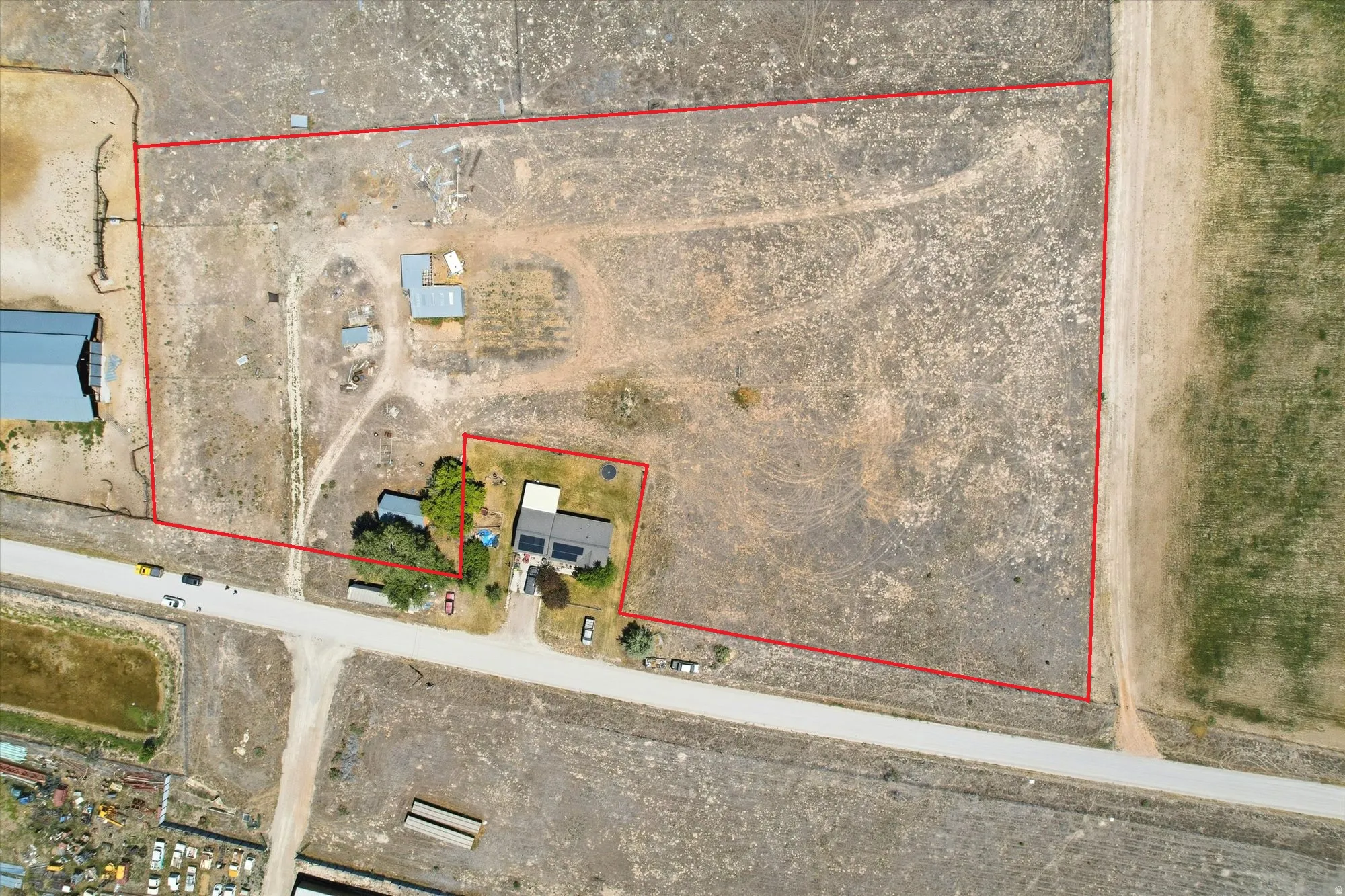 Aerial perspective showcasing a sprawling property with multiple structures