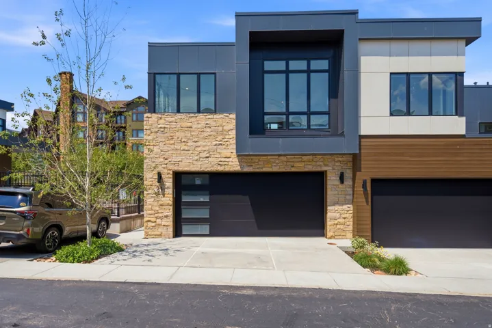 Contemporary exterior featuring a stone and panel facade