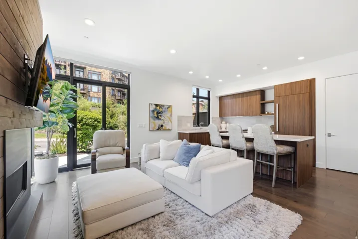 Open-concept living space featuring wood-finish flooring and recessed lighting