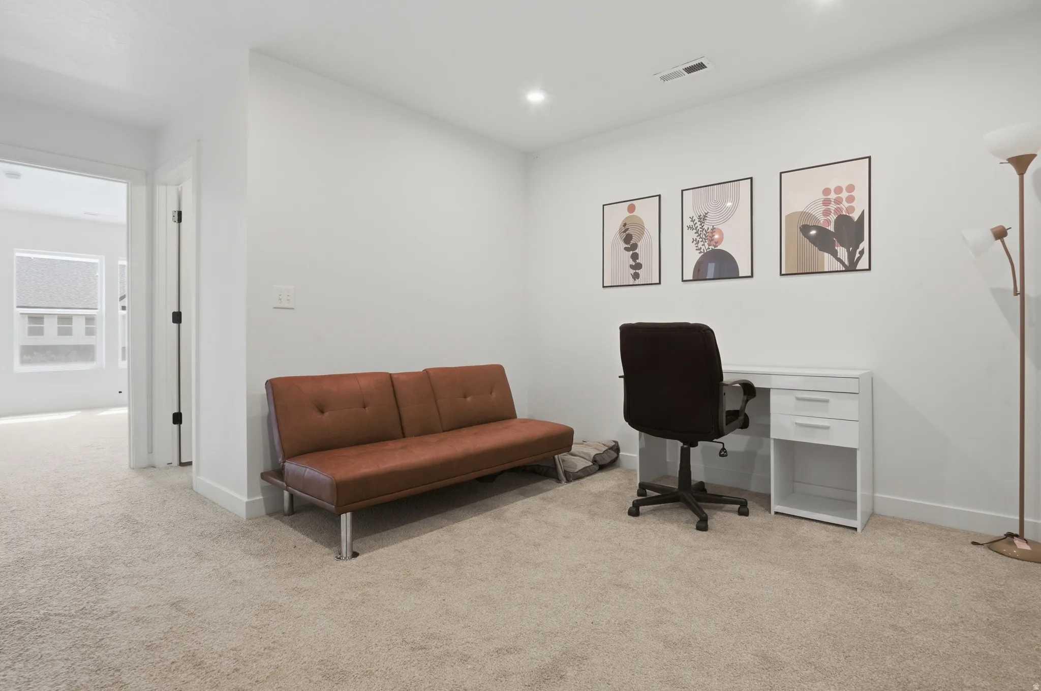 Carpeted room with recessed lighting and white baseboards