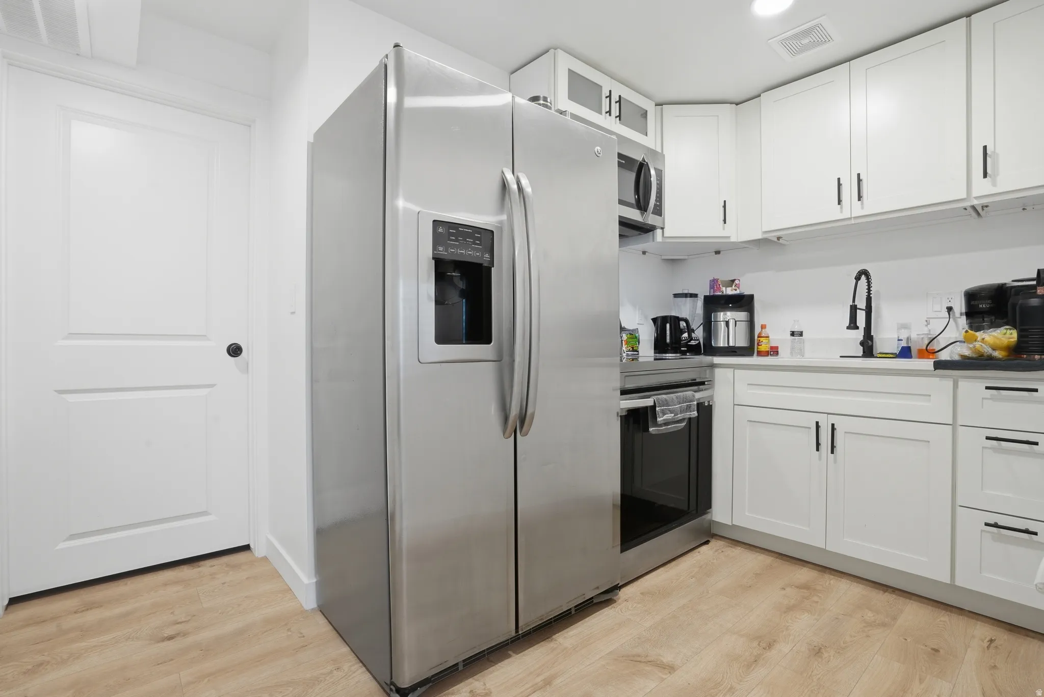 Stainless steel French door refrigerator with an ice and water dispenser