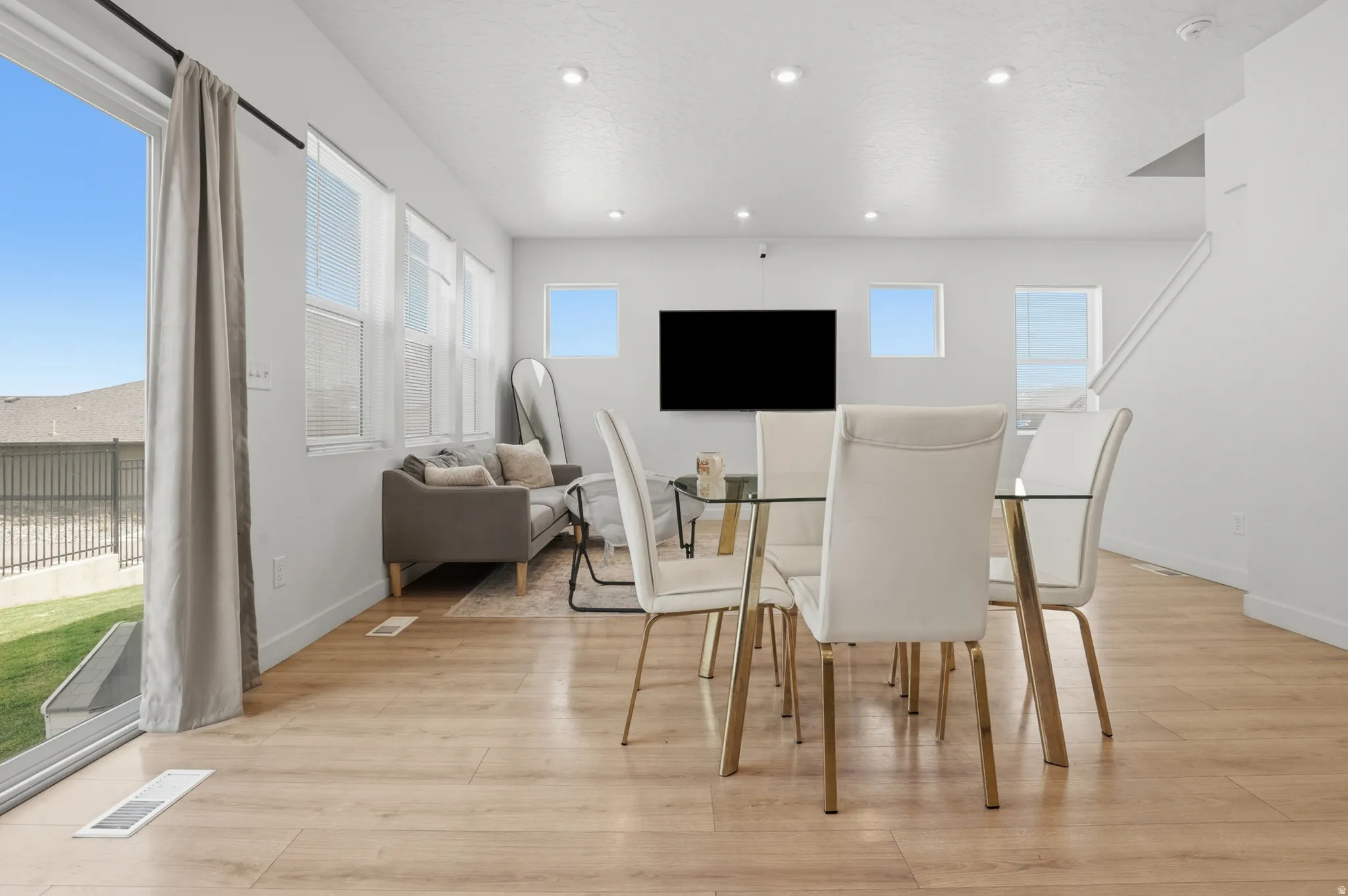 Open-concept living space featuring wood-finish flooring and recessed lighting