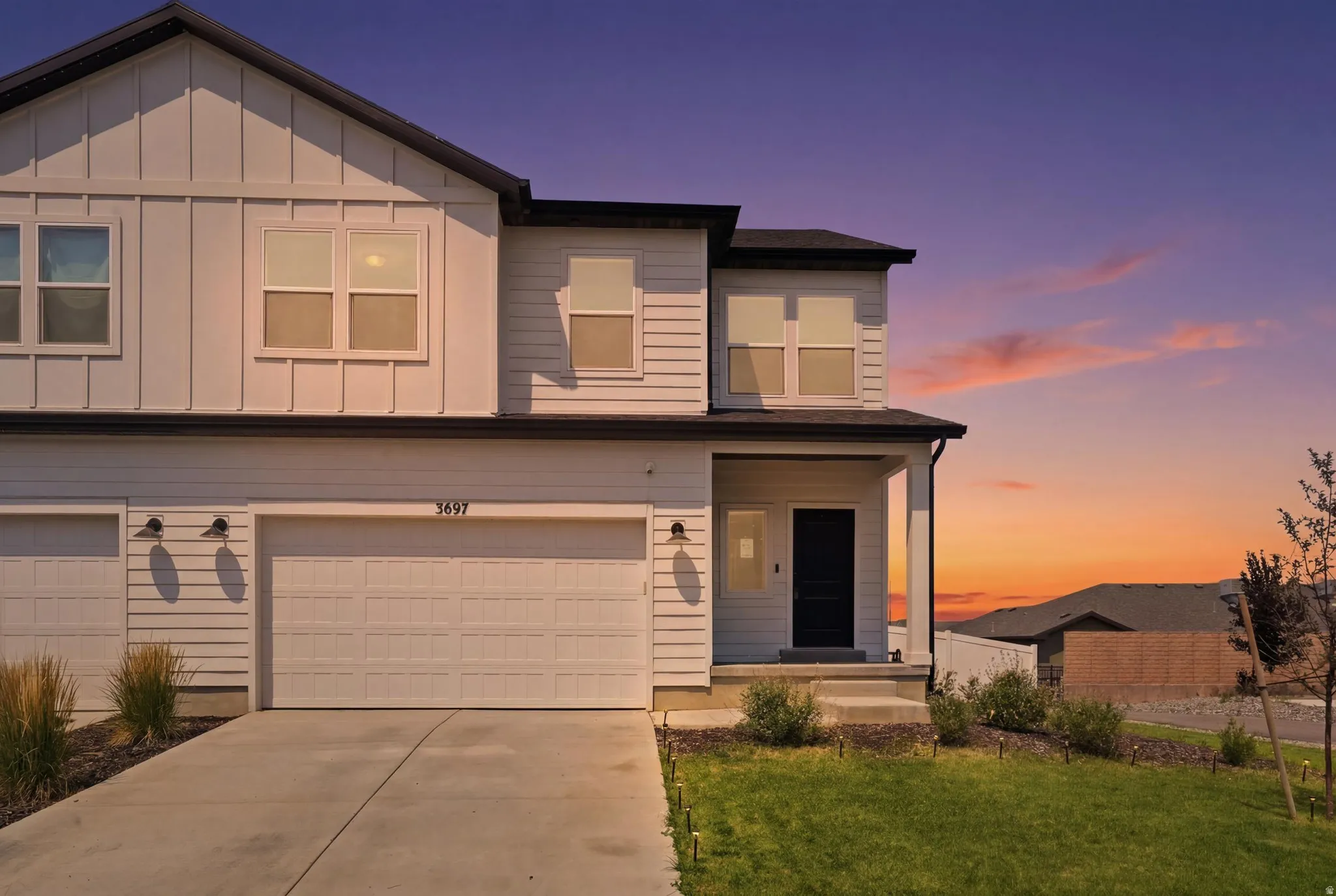 Modern two-story residence featuring white horizontal and vertical siding