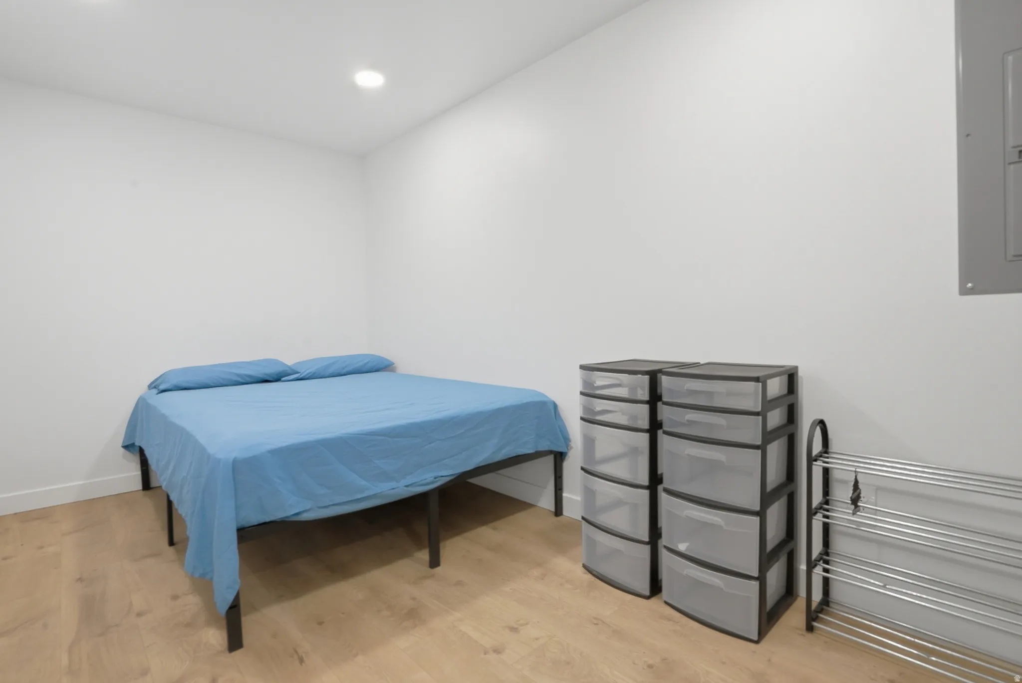 Bright room featuring recessed lighting, light wood-finish flooring, white baseboards, and a neutral color palette
