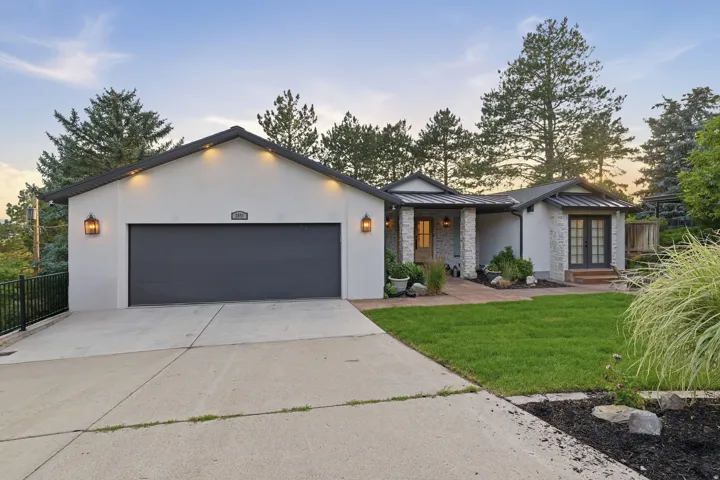 Contemporary exterior with white stucco and stone accents