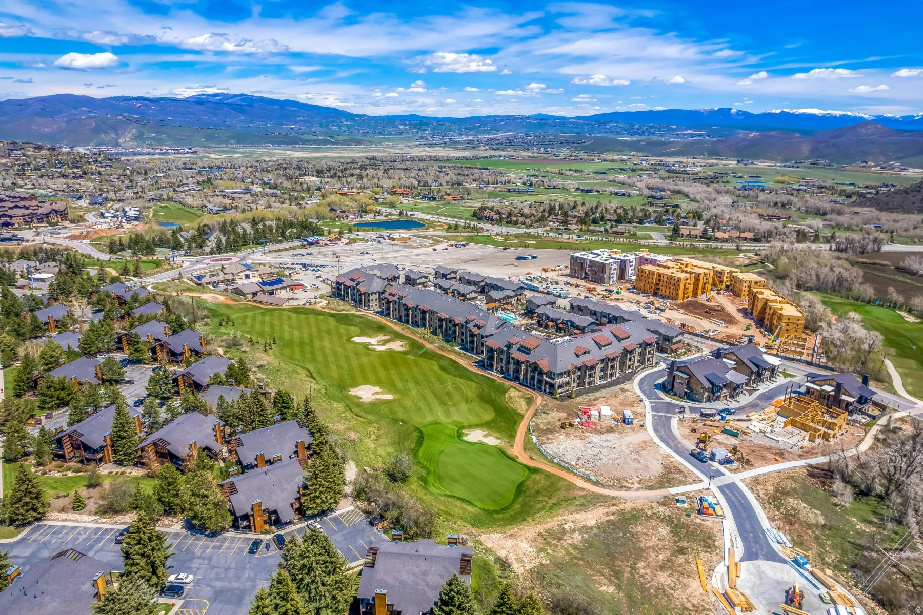 Expansive golf course property with multiple residential structures and mountain scenery