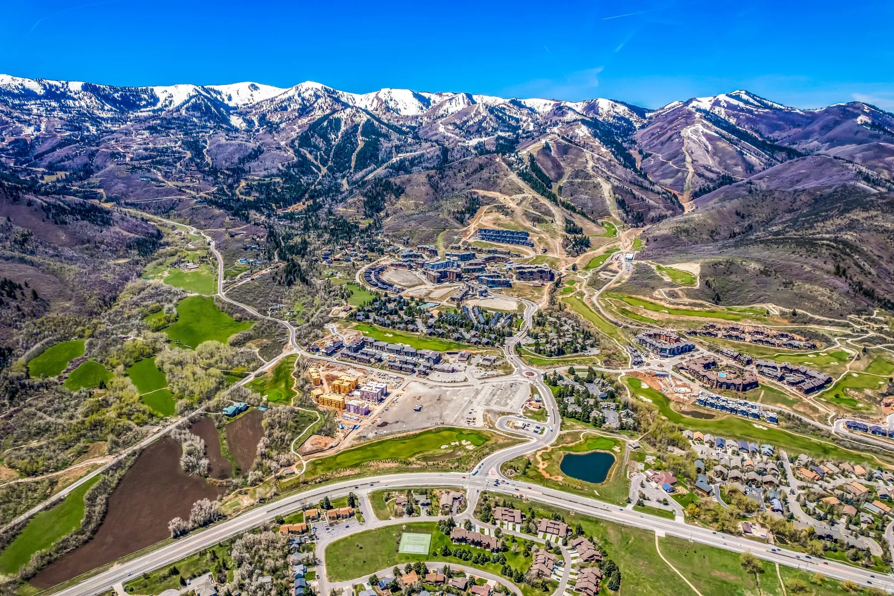 Aerial panorama showcasing a mountainous landscape with snow-capped peaks