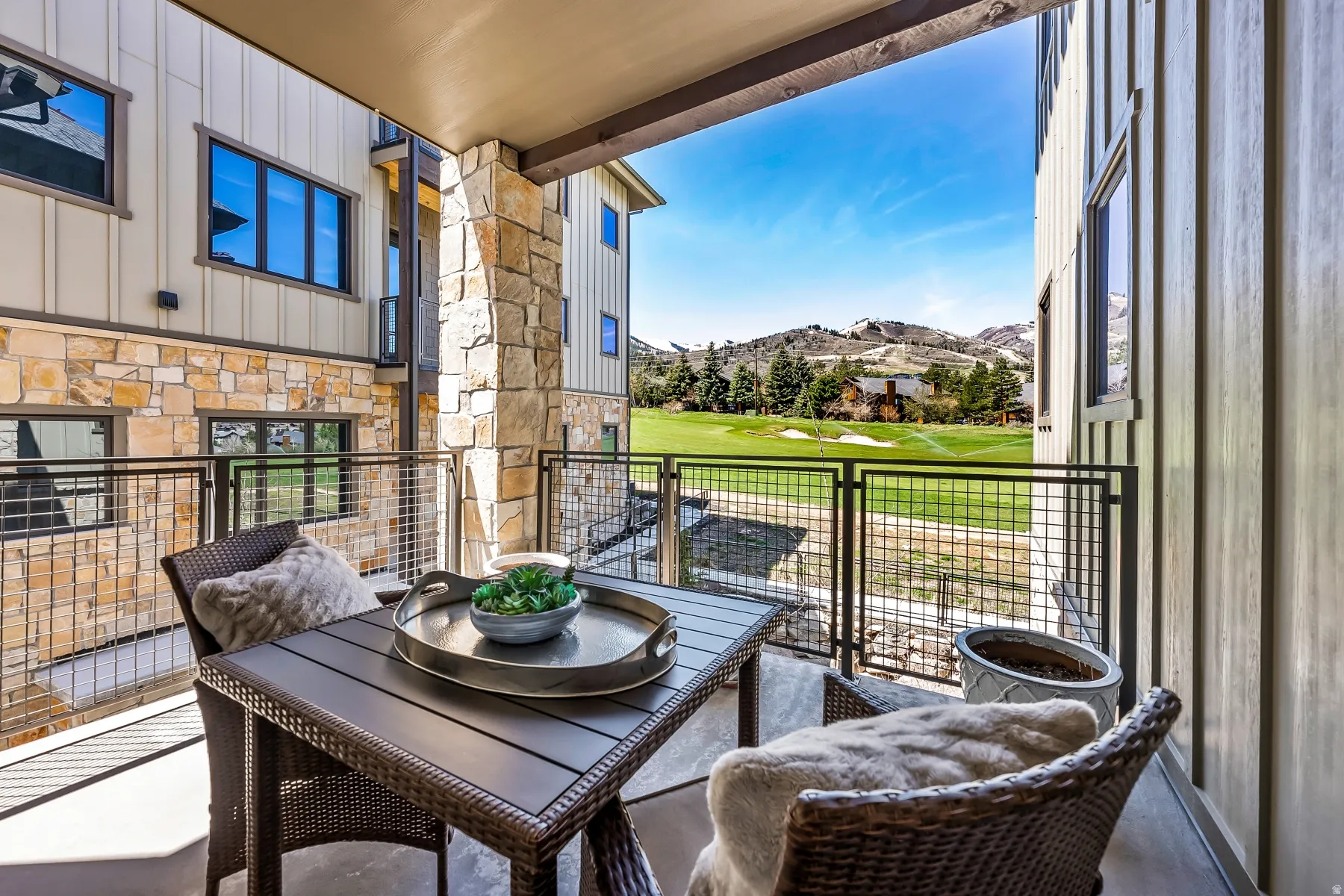 Covered balcony with a concrete floor and a metal railing