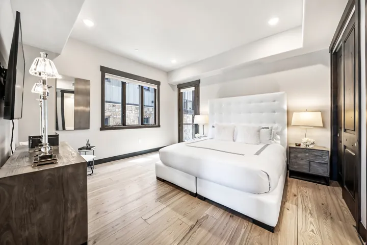 Spacious room featuring light wood-finish flooring and recessed ceiling lighting