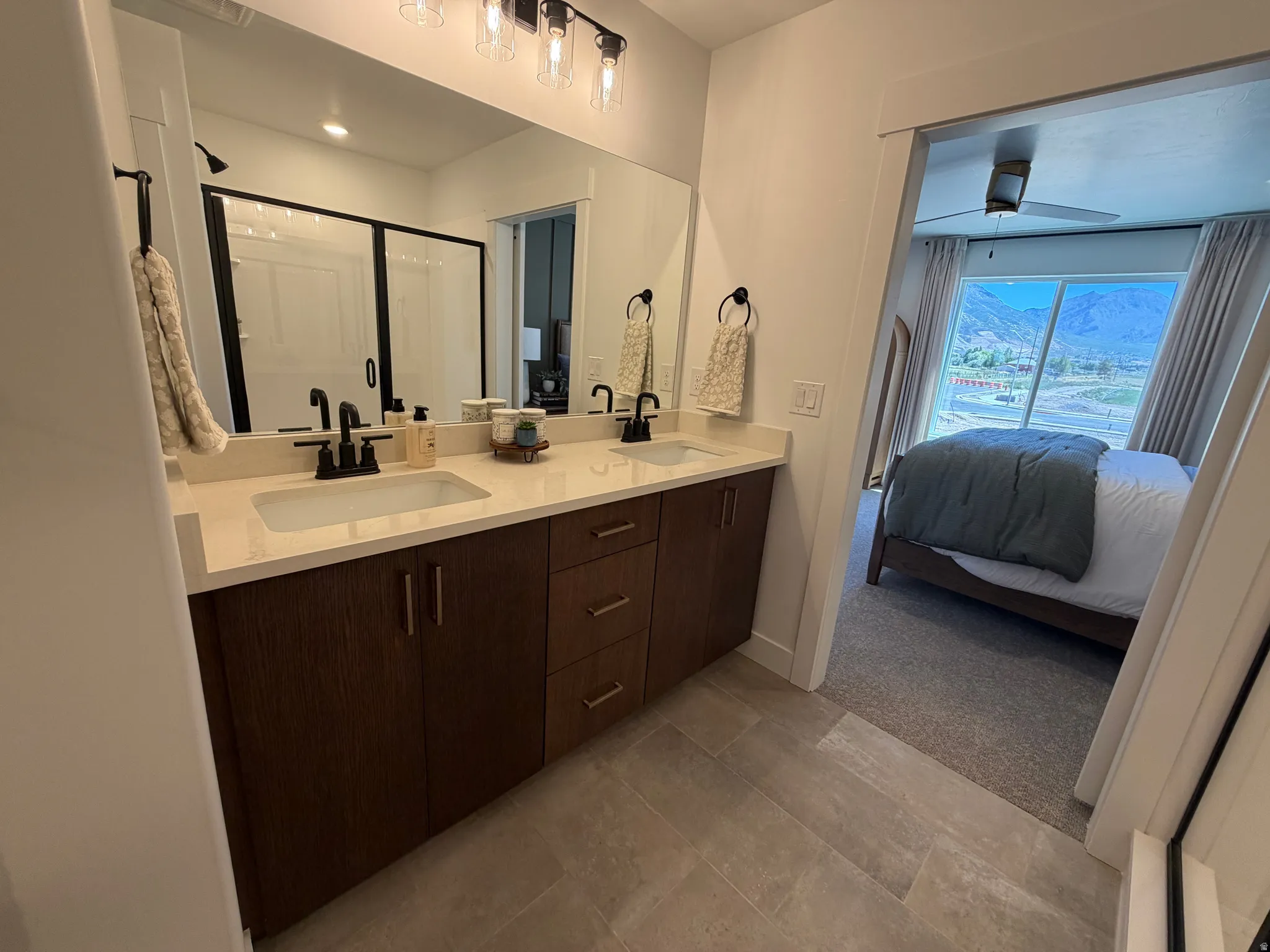 Dual vanity with stone-finish countertop, undermount sinks, and matte black fixtures