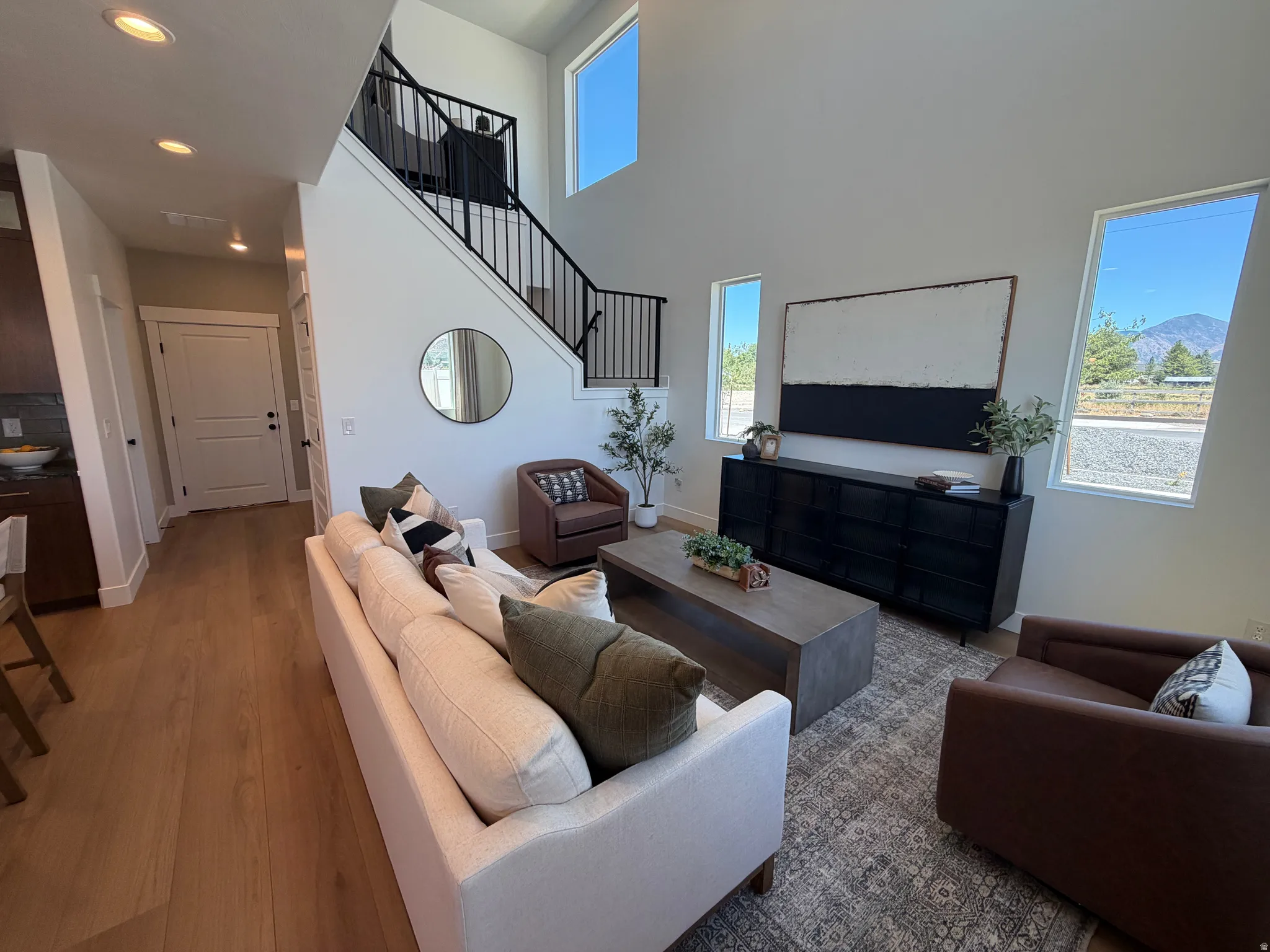 Expansive living area featuring soaring ceilings and wood-finish flooring