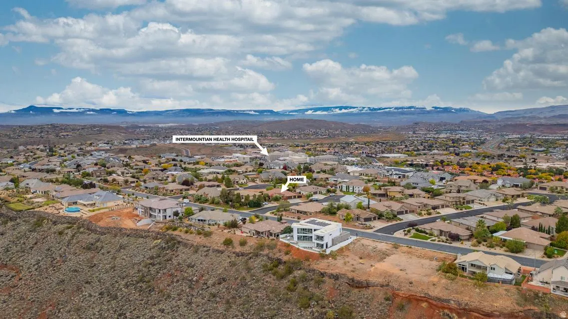 Aerial panorama showcasing a residential community with distant mountains