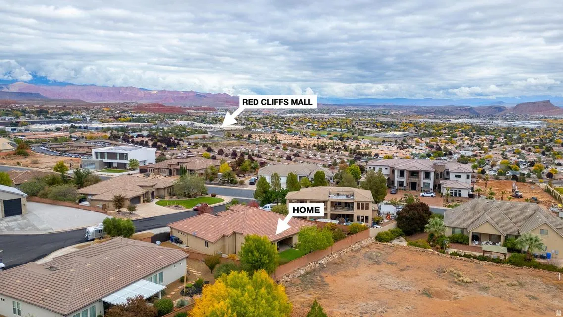 Aerial perspective showcasing a residential neighborhood with distant red rock formations