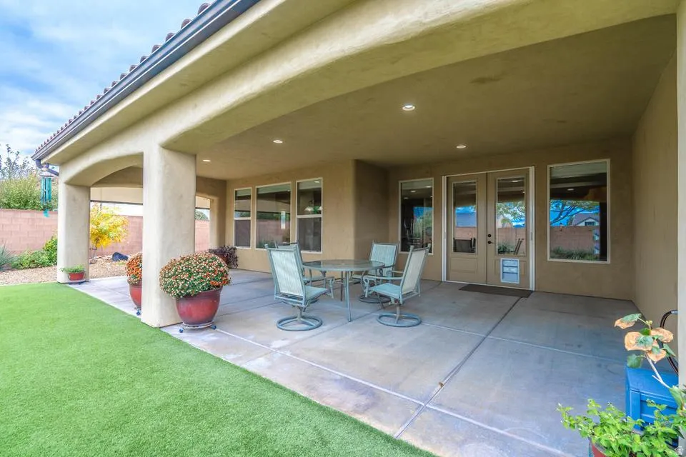 Spacious covered patio featuring concrete flooring, recessed lighting, and multiple window and door access points
