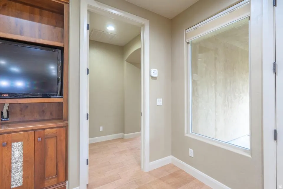Built-in entertainment center featuring warm wood cabinetry and a decorative tile inlay