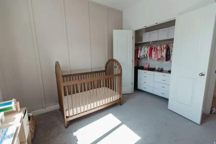 Room featuring light gray paneled walls and coordinating carpeting