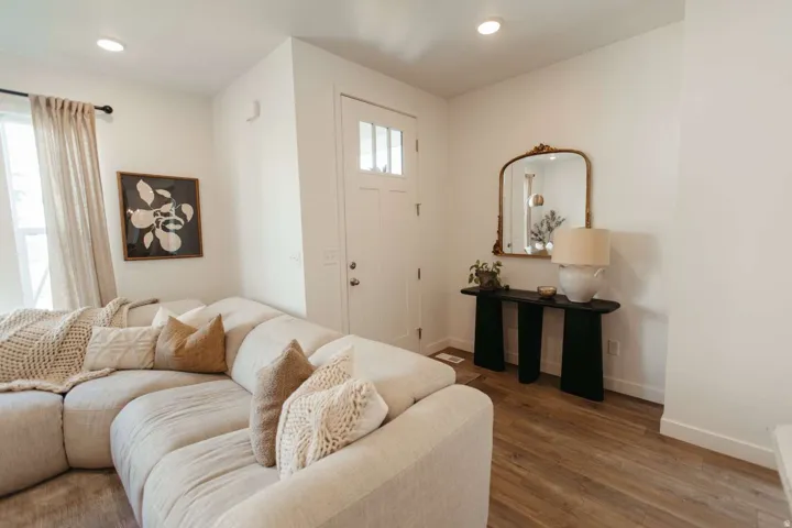 Entryway with wood-finish flooring, white walls, and a multi-pane front door