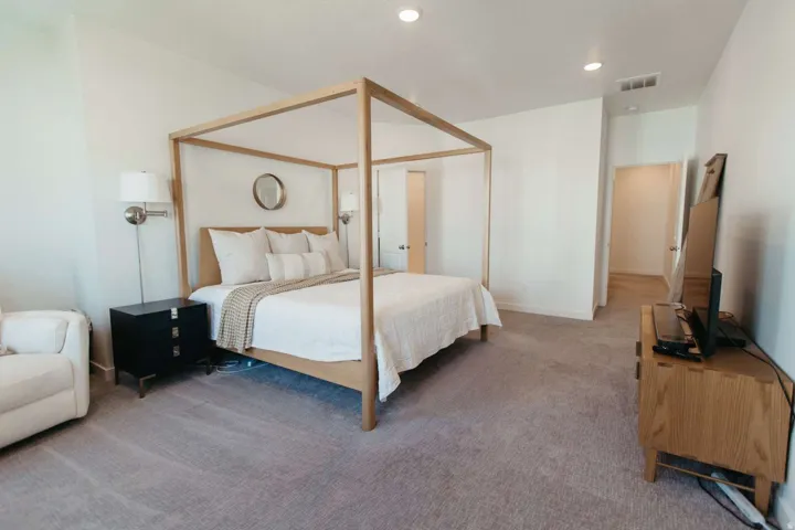Spacious room featuring light gray carpeting, recessed ceiling lighting, and a neutral wall color