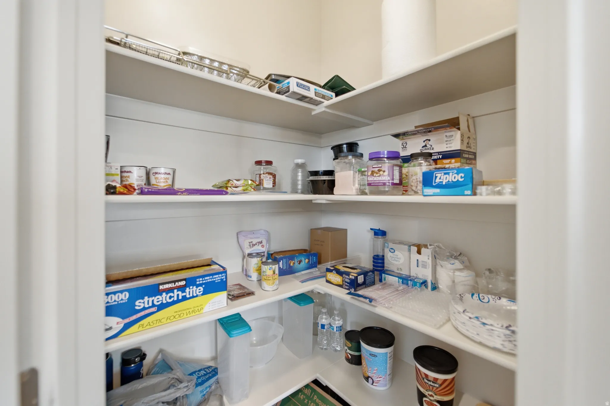 Corner pantry featuring multiple fixed shelves