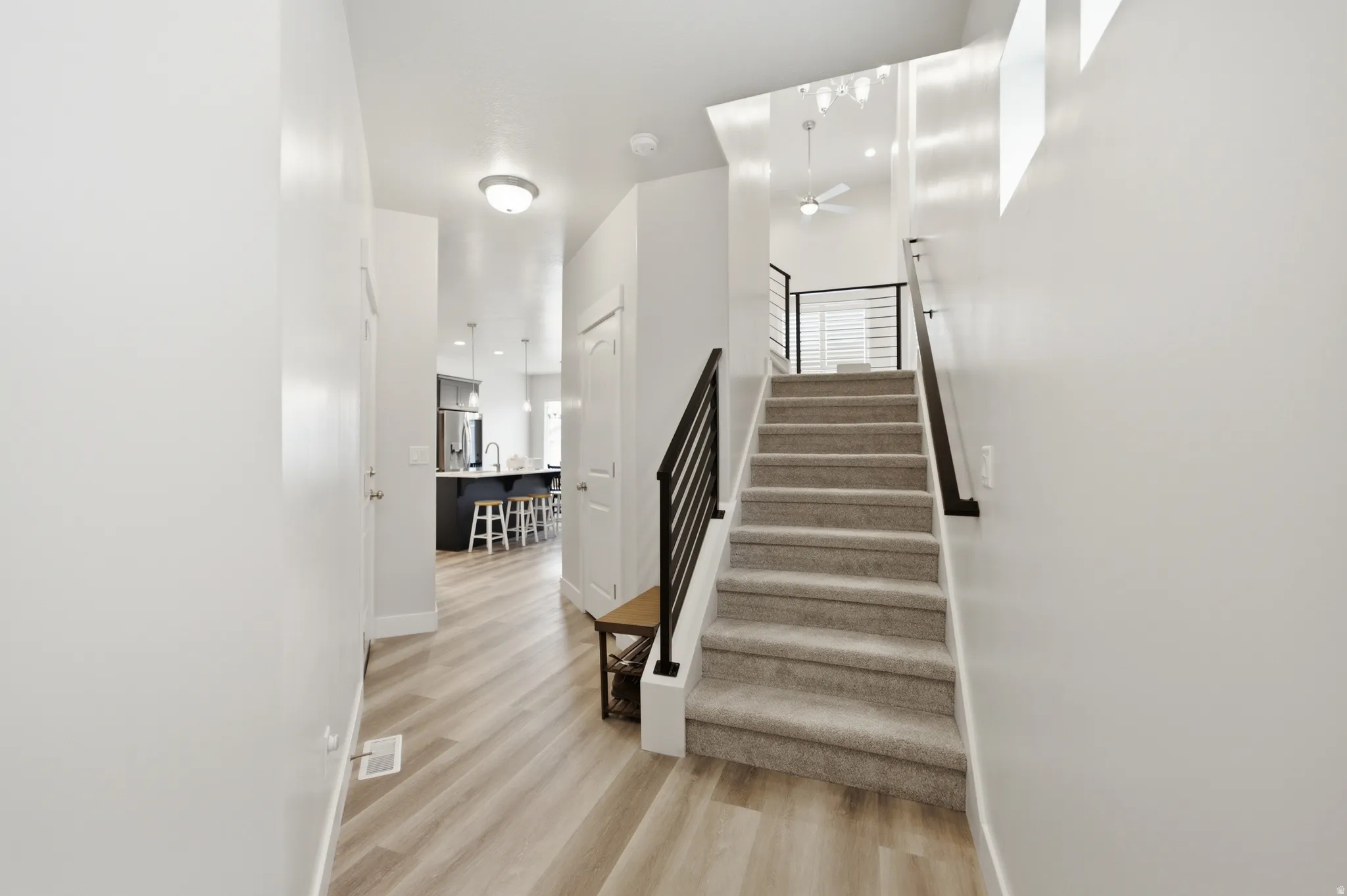 Entryway featuring wood-finish flooring extending into the kitchen