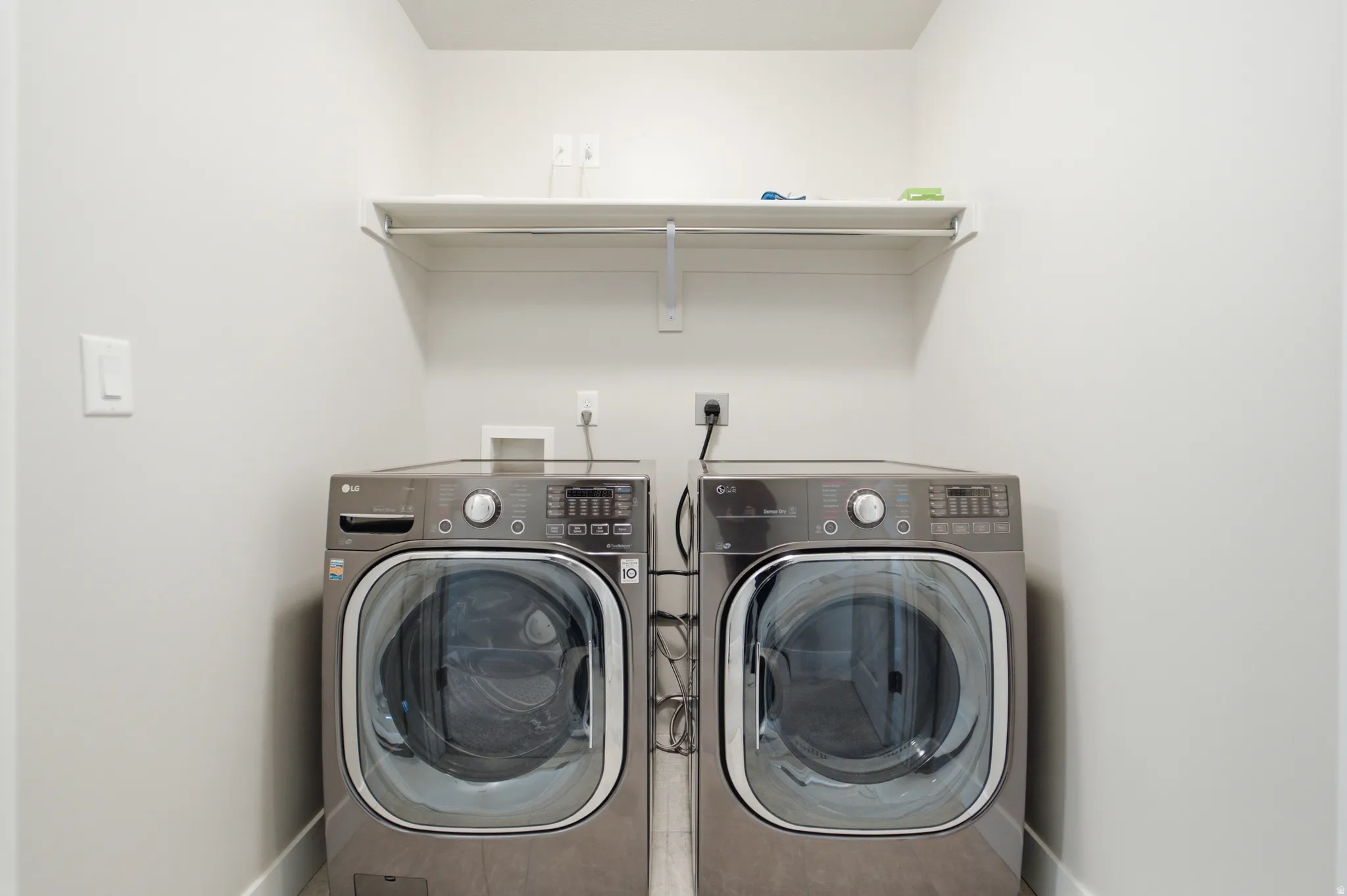 Dedicated utility space featuring a built-in shelving unit and a hanging rod