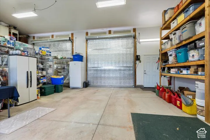 Two overhead garage doors with a concrete floor