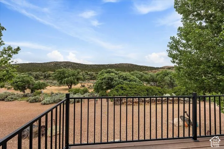 Wood-finish deck with a black metal railing