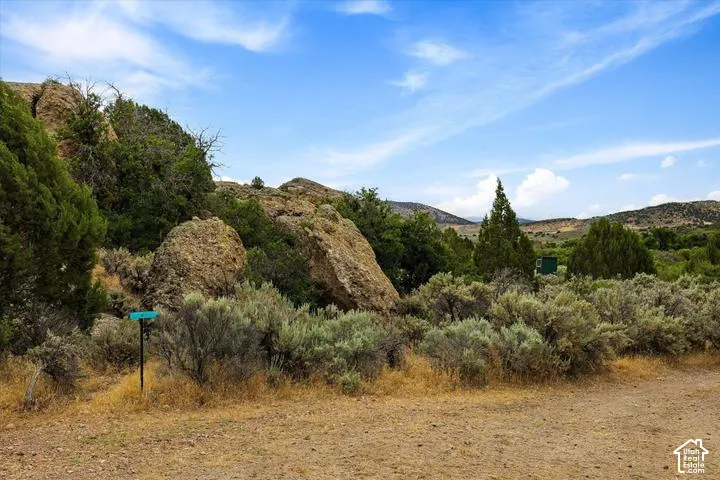 Expansive natural landscape featuring varied terrain with prominent rock formations and diverse native vegetation