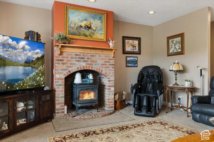 Brick fireplace with an arched opening, a wood-burning stove, and a wood mantelpiece
