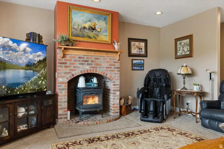 Brick fireplace with an arched opening, a wood-burning stove, and a wood mantelpiece