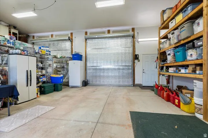 Two overhead garage doors with a concrete floor