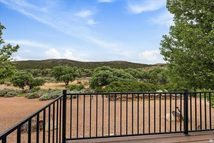 Wood-finish deck with a black metal railing
