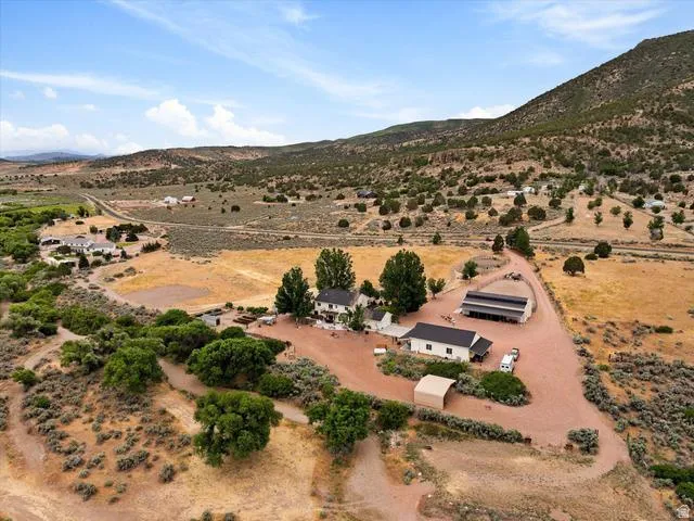 Expansive rural property featuring multiple structures, including two residential buildings and an extensive barn