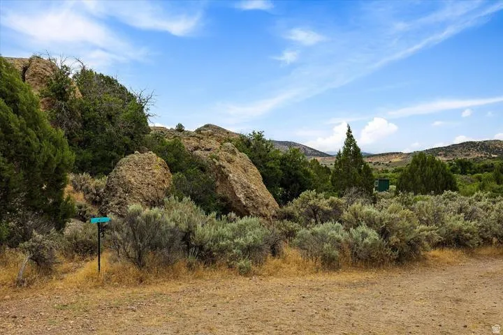 Expansive natural landscape featuring varied terrain with prominent rock formations and diverse native vegetation