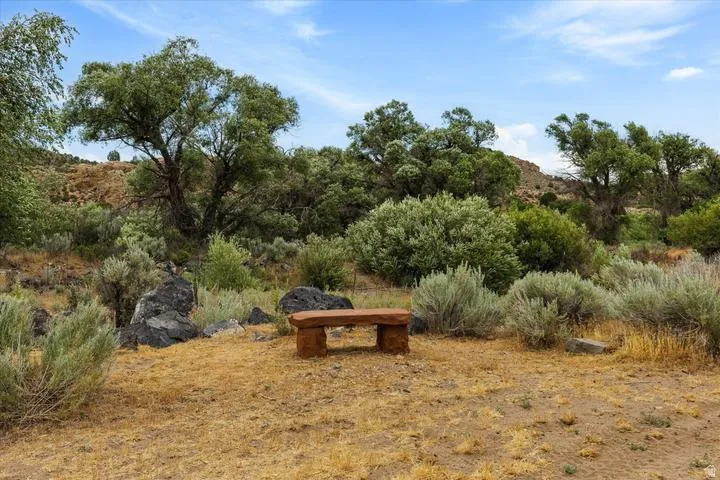Outdoor seating area featuring a rustic stone bench
