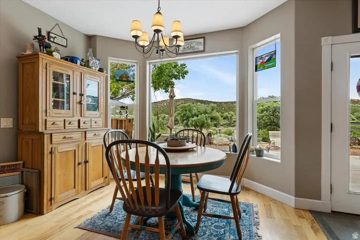Dining area featuring a bay window with a natural landscape backdrop