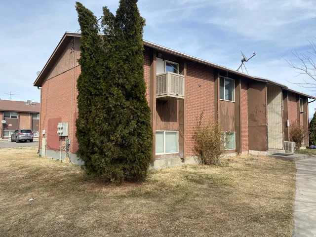 Brick and siding exterior with a second-story balcony
