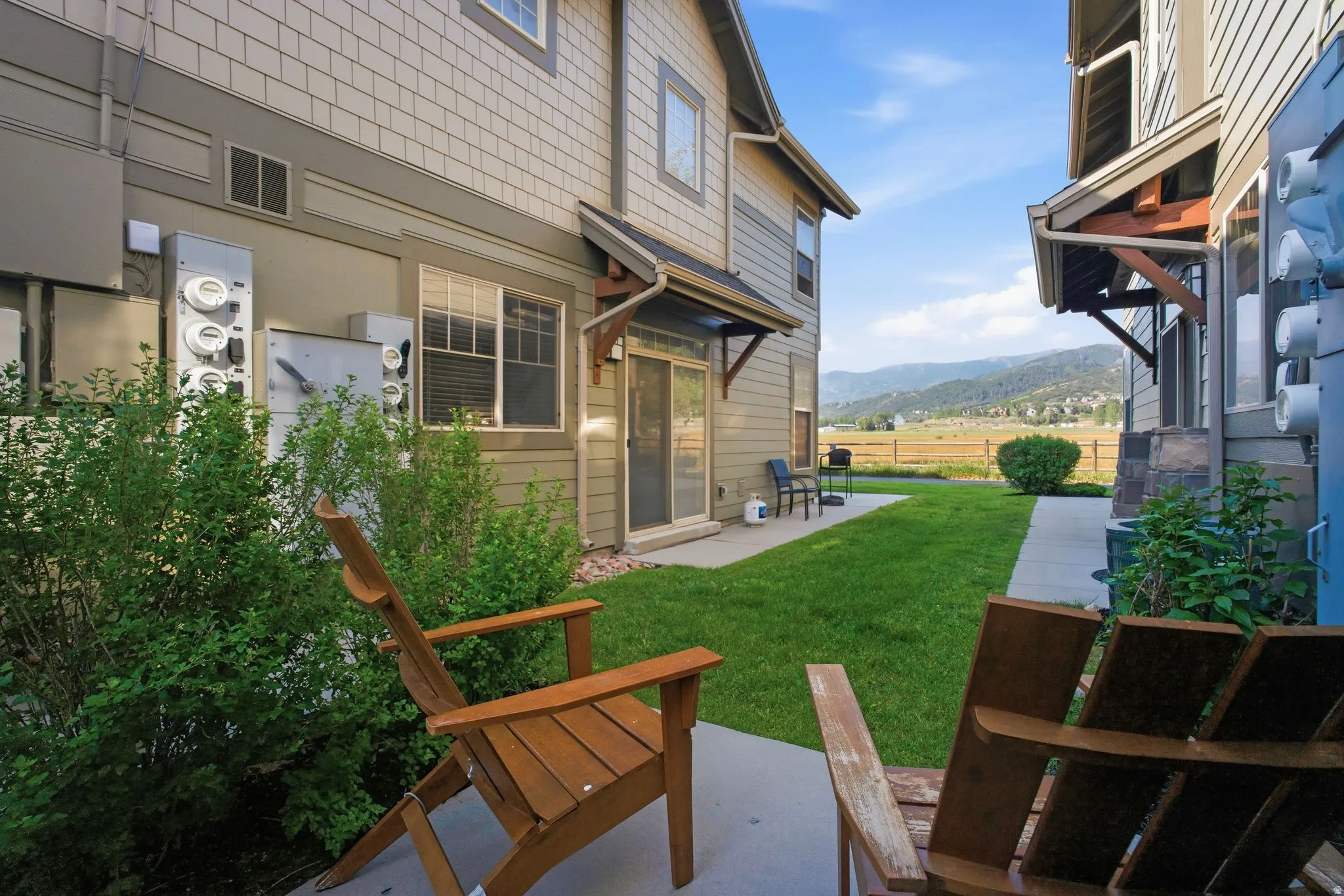 Private concrete patio with lush green lawn