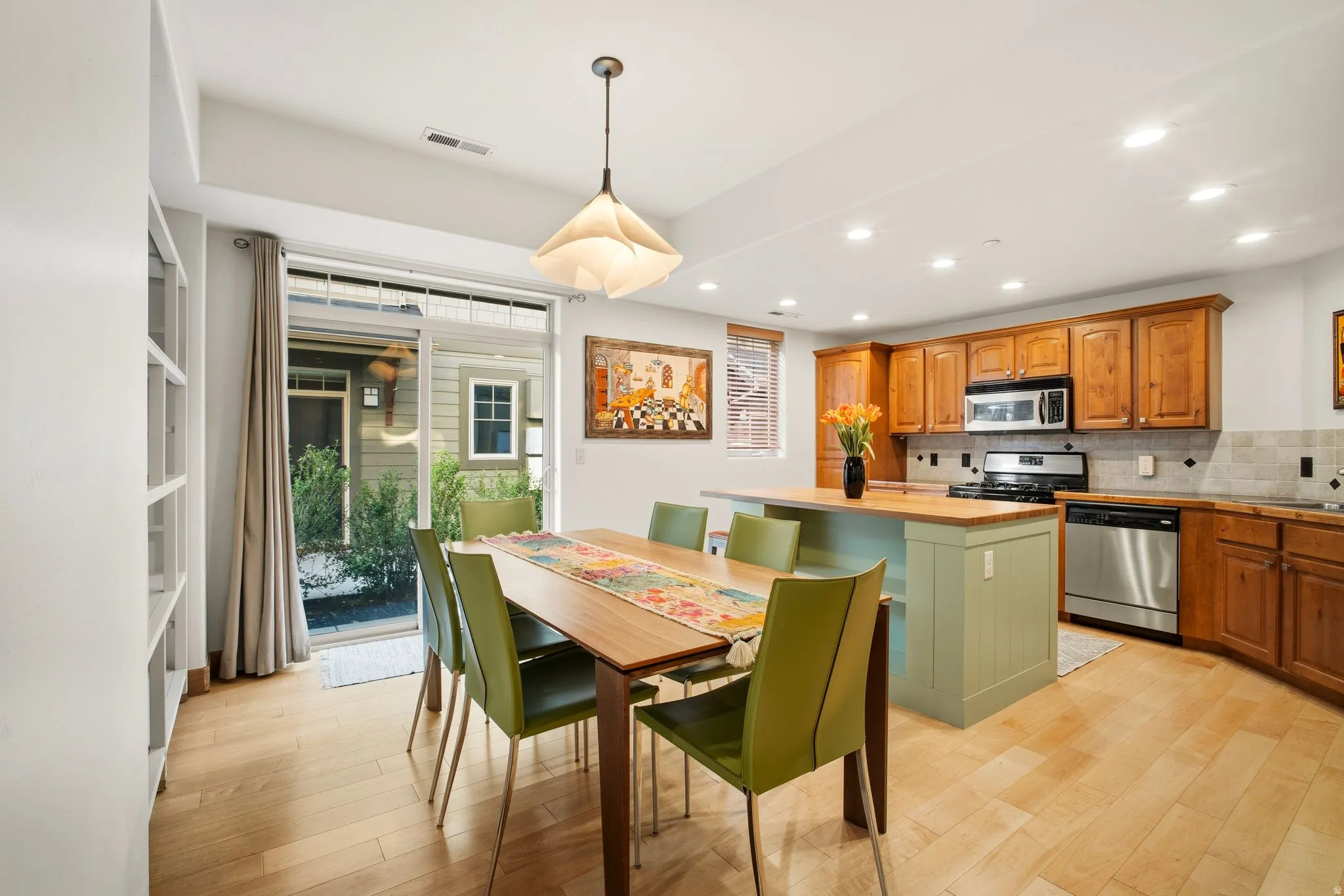 Kitchen and dining area featuring wood-finish flooring