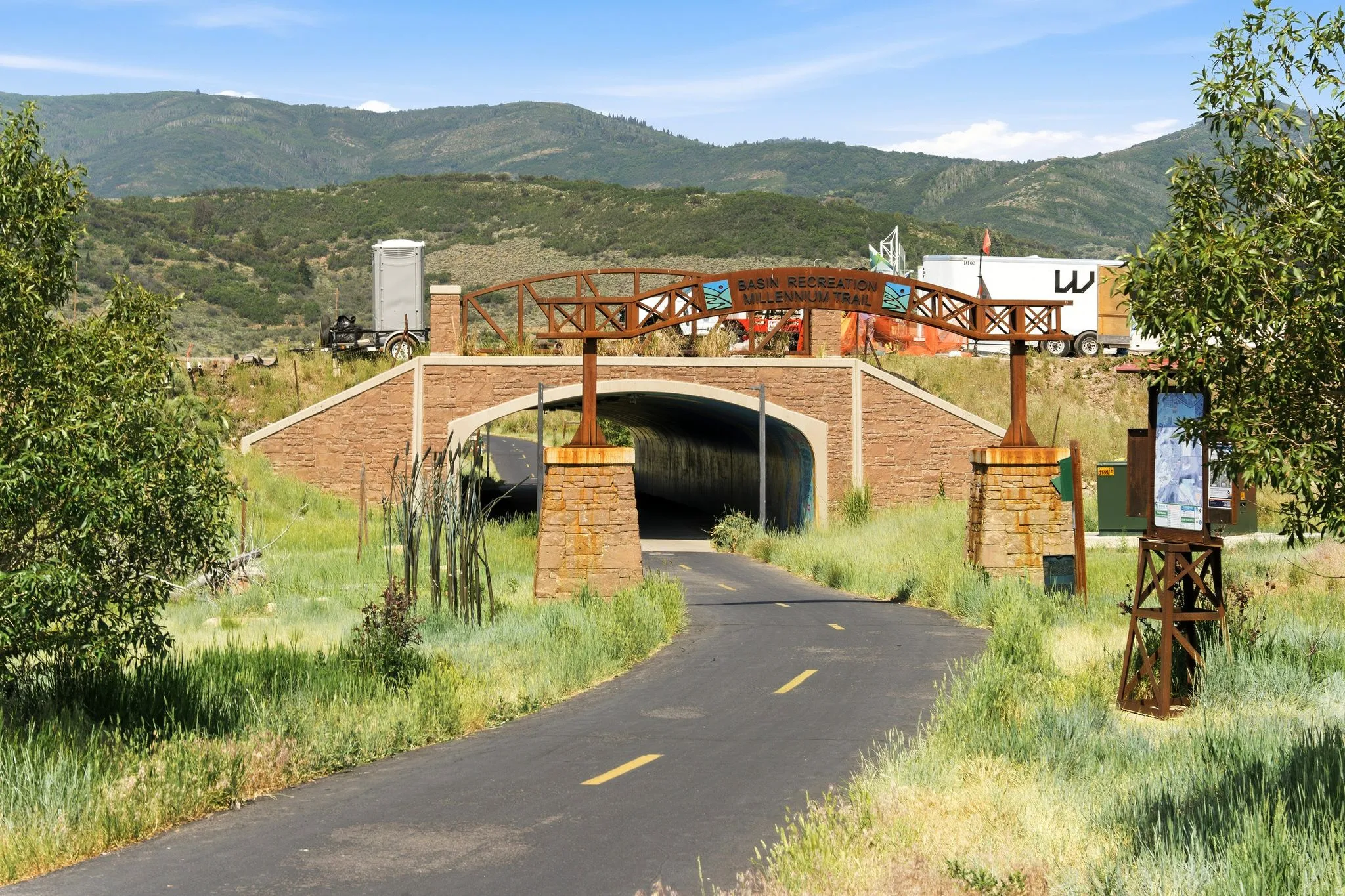 Paved pathway leading to an arched stone underpass