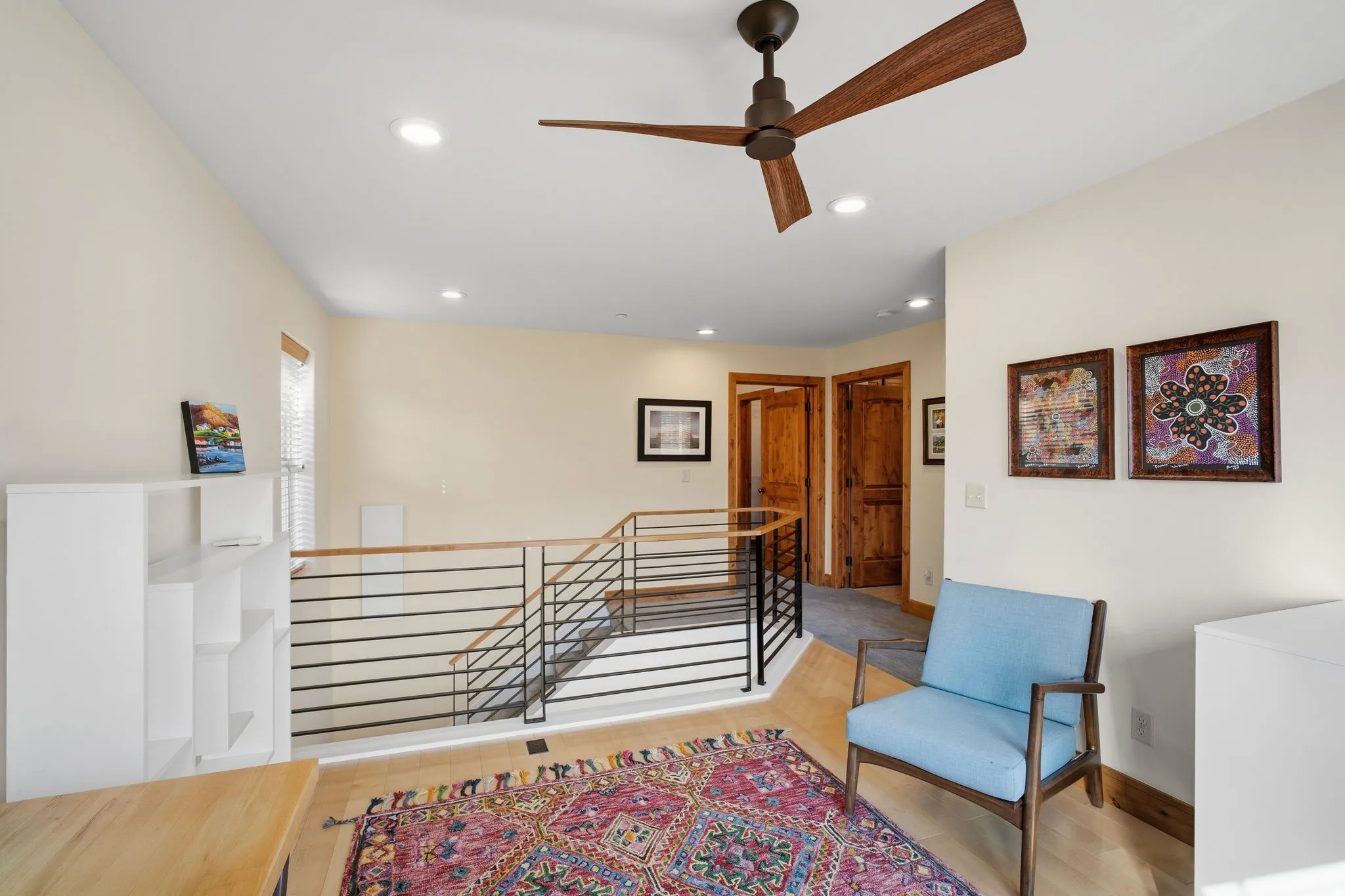 Upper-level landing featuring a wood-finish flooring, recessed lighting, and a modern ceiling fan