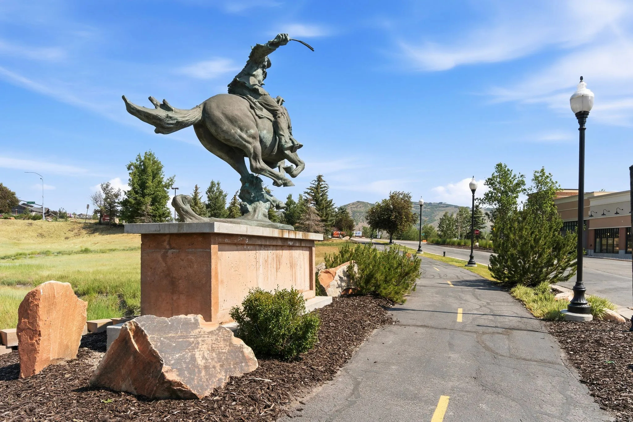 Bronze equestrian statue on a stone pedestal with natural rock landscaping elements