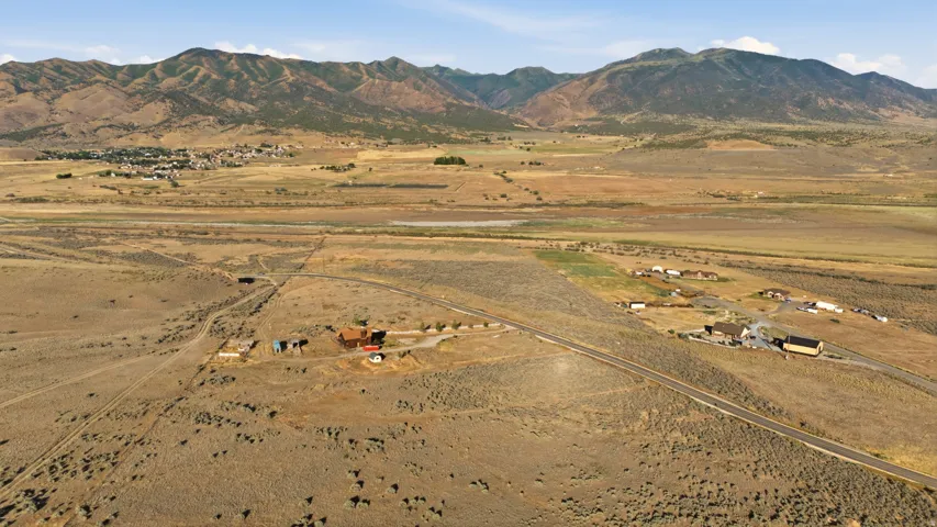 Expansive rural landscape featuring a mountainous backdrop