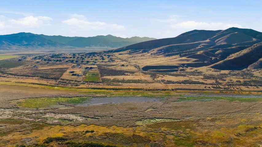 Expansive mountain scenery framing a distant settlement and natural terrain