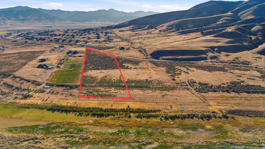 Expansive land parcel outlined in red, featuring natural vegetation and undeveloped terrain