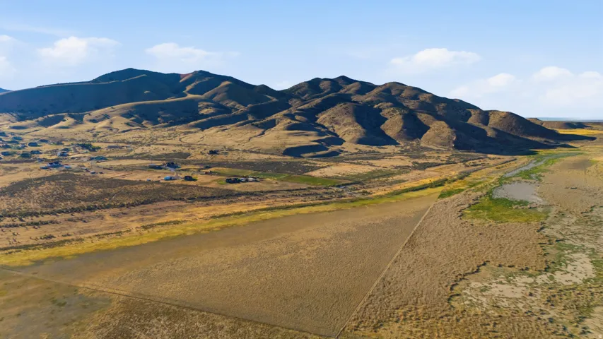 Expansive terrain featuring varied vegetation and distant mountain ranges
