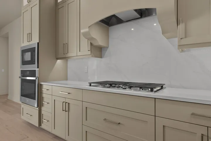 Built-in stainless steel double ovens and microwave complement light-toned cabinetry