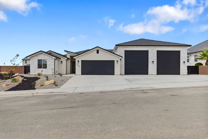 Contemporary exterior with white brick and stucco finishes